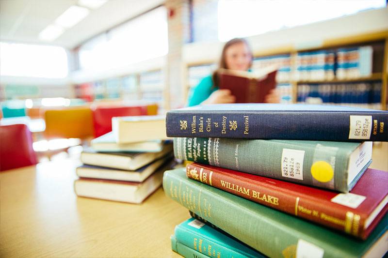 An English literature degree student reads in the library at WSC