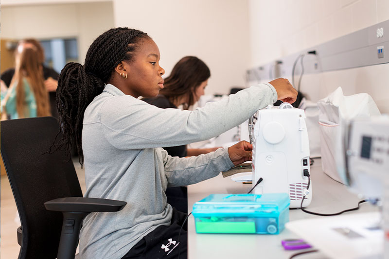 An FCS degree student works in the textiles lab at WSC