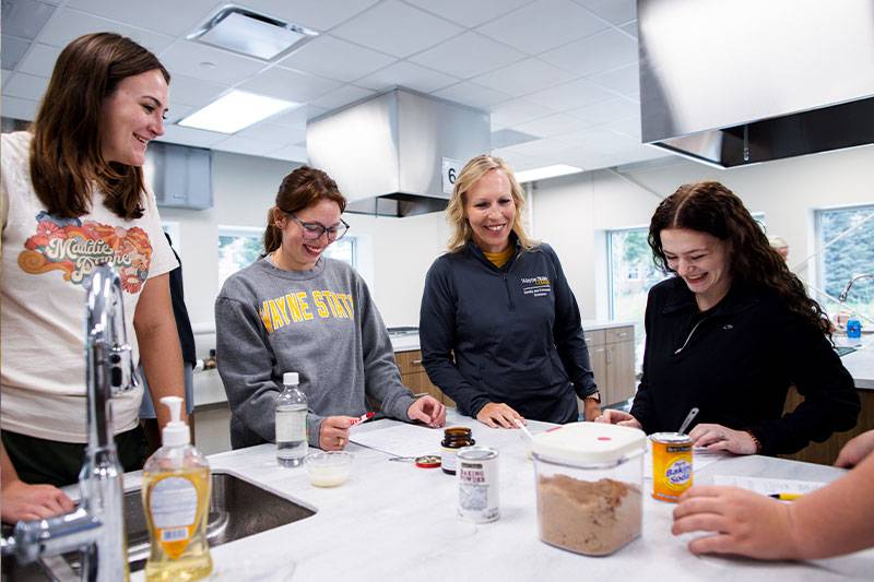 FCS education degree students work with a professor in the foods lab at WSC
