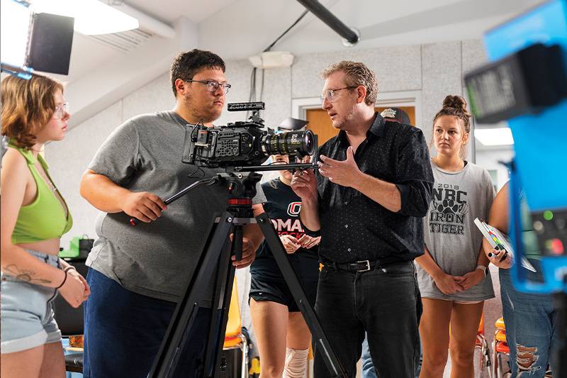A film instructor leads a digital film production classroom