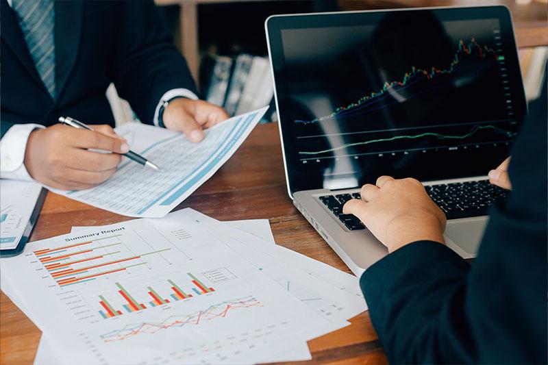 Two people reviewing financial reports