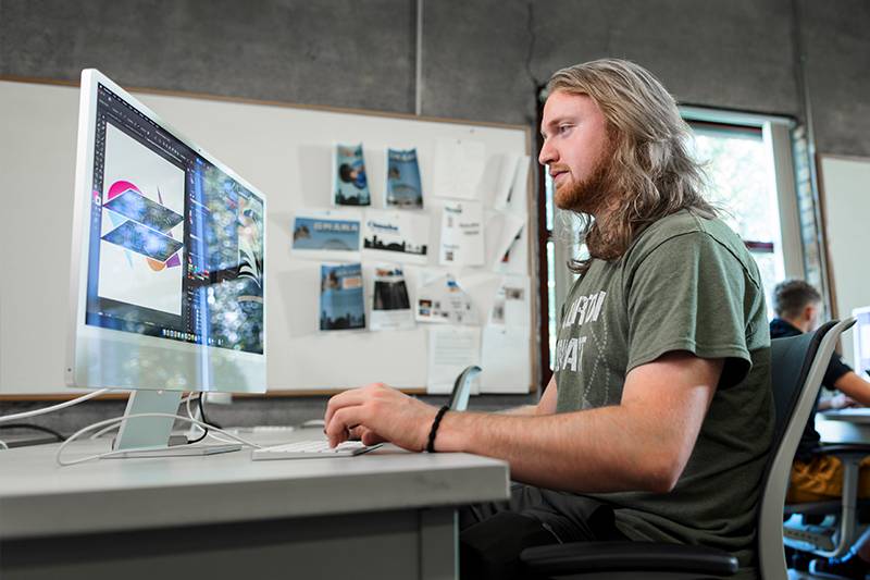 A graphic design degree student in a Mac lab at WSC