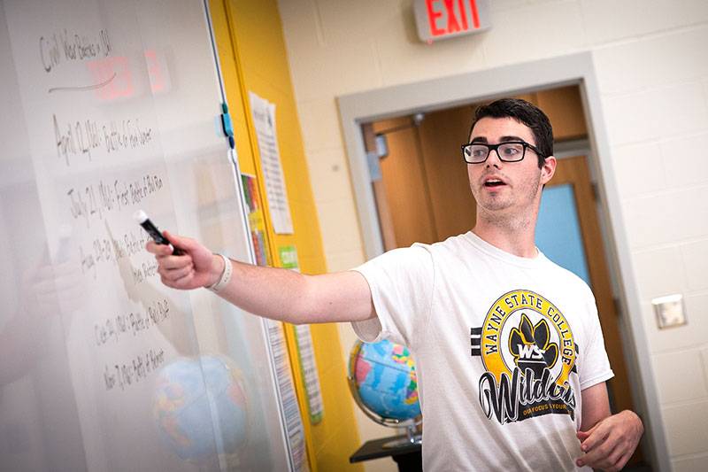 A history education degree student leads instruction in a classroom
