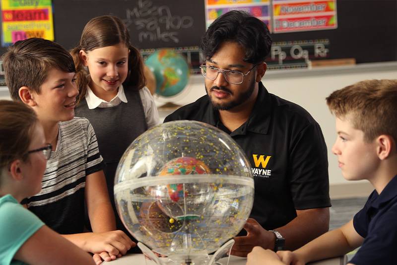 A middle level education degree student works with middle school kids in Wayne