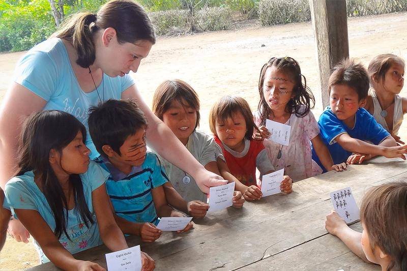 A student works with non-English-speaking students
