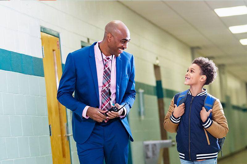 A principal talks with a student