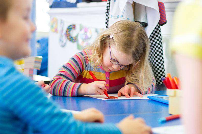 A student colors a picture