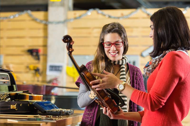 Music industry degree concept featuring students in a music store