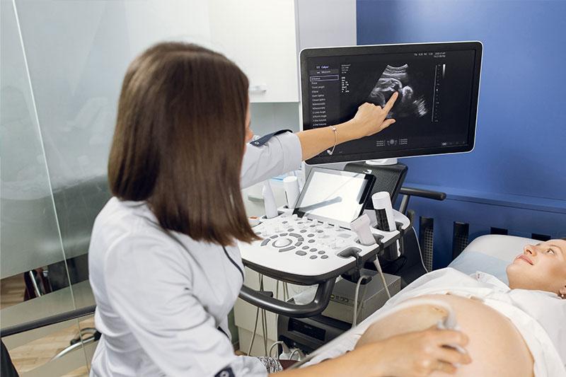A female doctor conducts an ultrasound on a pregnant woman