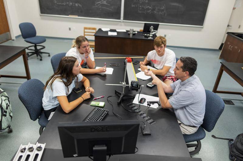Pre-Engineering program concept with students in a physics lab