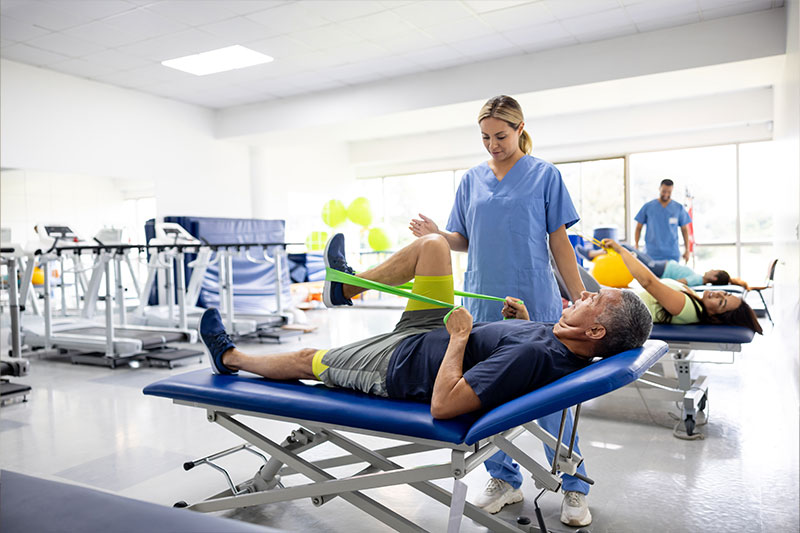 Pre physical therapy degree concept featuring a PT working with a patient