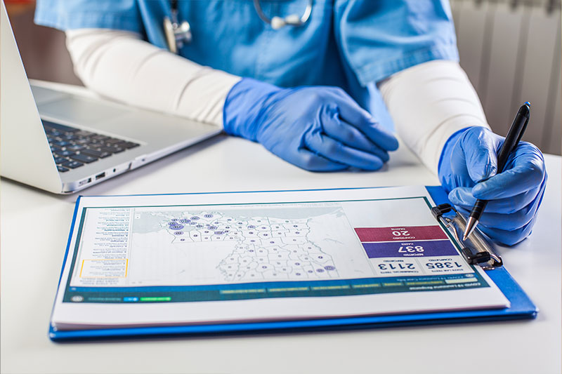 Public health degree concept featuring an epidemiologist at a computer