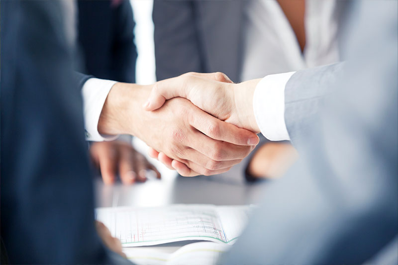 Professional studies degree concept featuring business leaders shaking hands