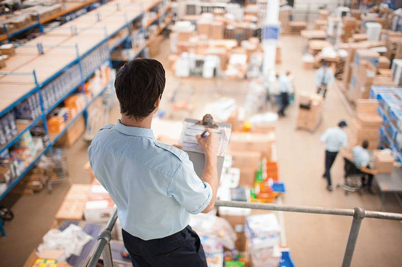 Supply chain management degree concept featuring a logistics manager at a warehouse