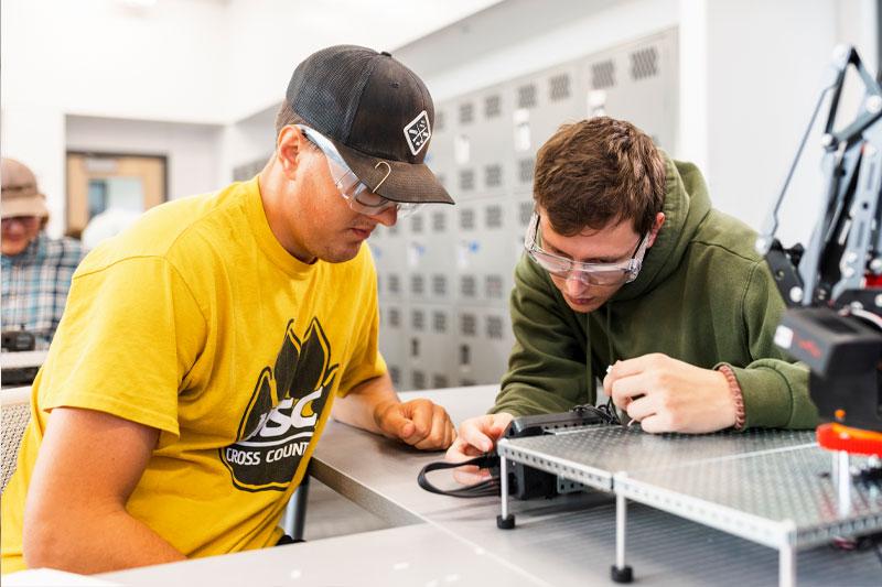 Technology degree concept featuring students in a robotics lab at WSC