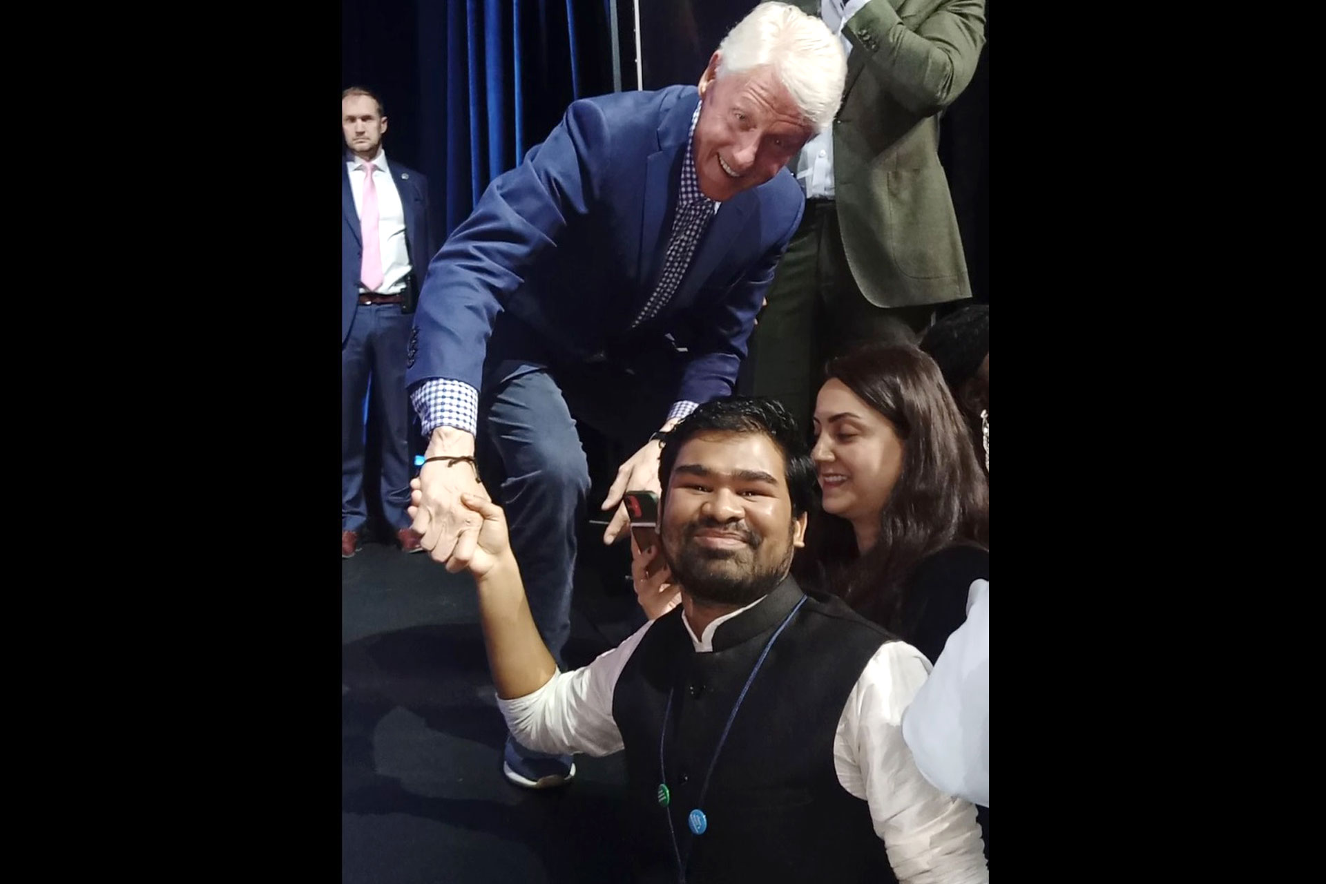 WSC student Roshan Yadav shakes hands with former President Bill Clinton