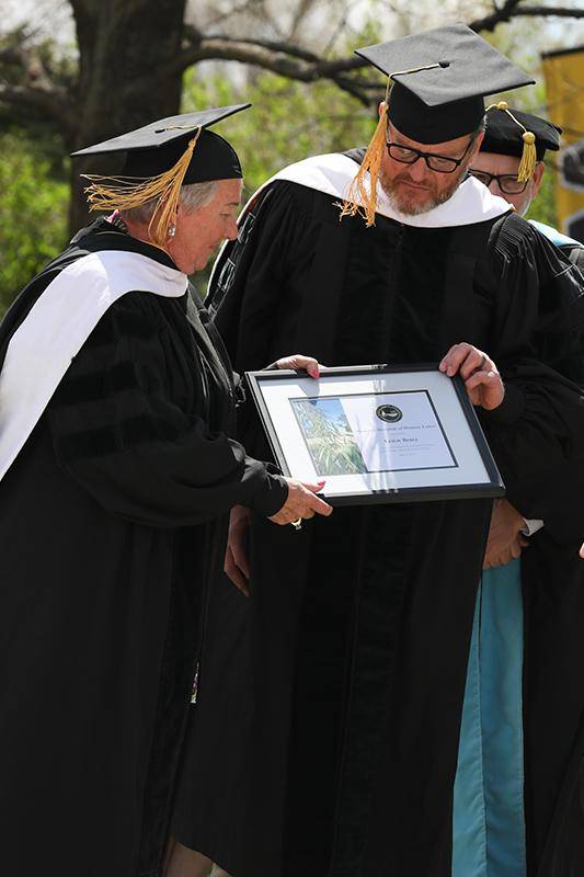 Leslie (left) and Tim Bebee receive their Honorary Doctorate of Humane Letters degrees during the Spring 2024 commencement ceremony