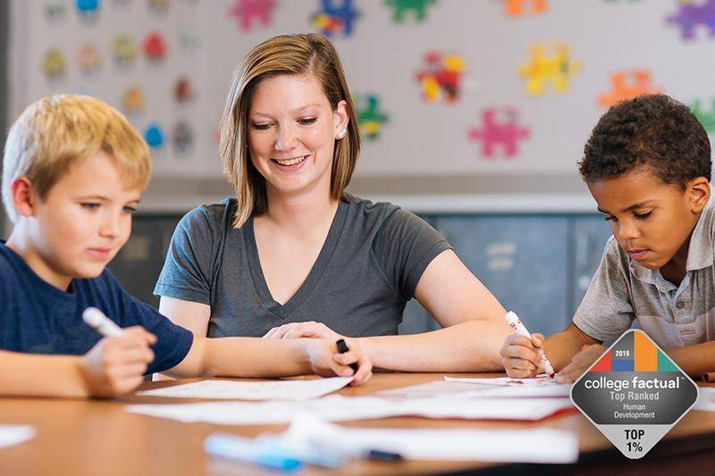 A student teacher works with two children
