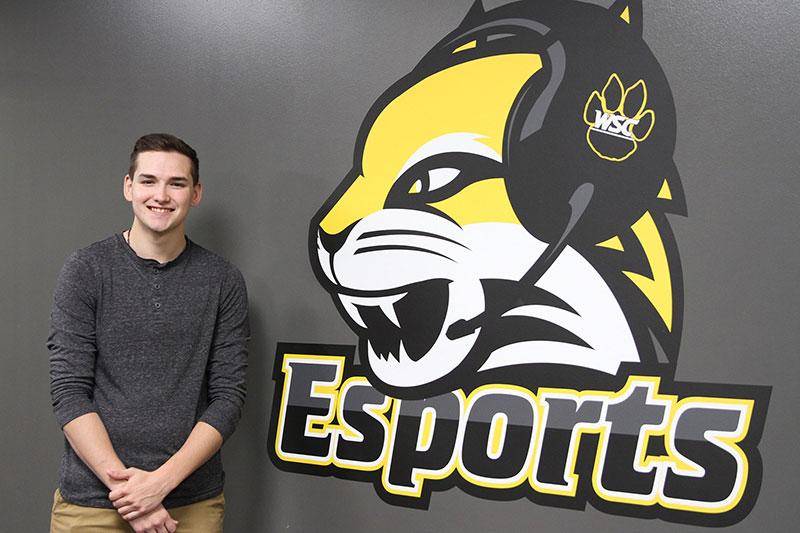 Photo of Drew Kurtenbach next to the esports logo
