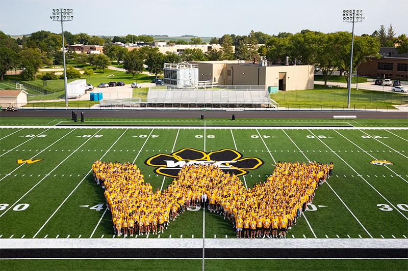 Photo of Class of 2030 students in a W shape on the football field