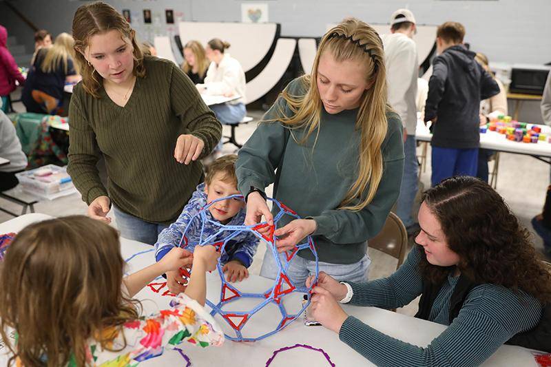 WSC students help elementary students during Family Math, Science, and Art Night.