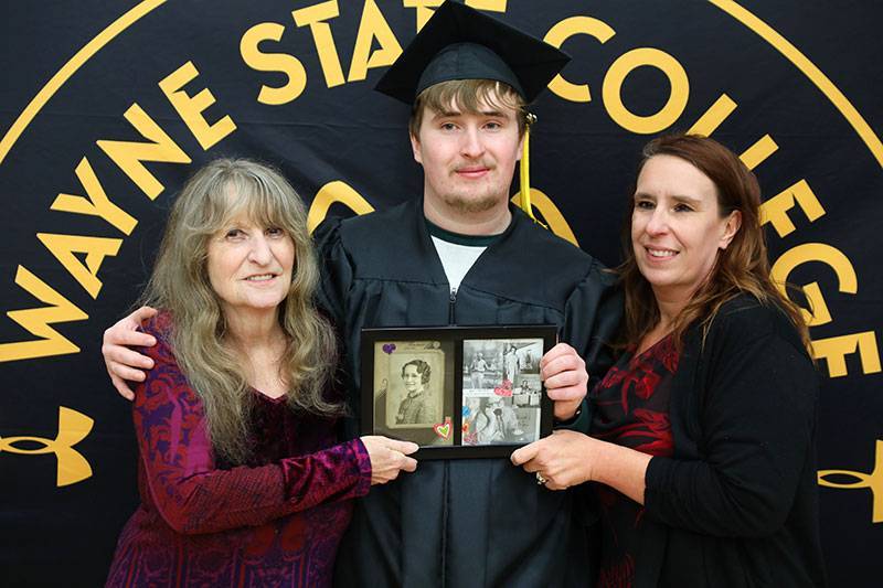 Joyce Schmitz Buskohl, Evan Brasch, and Stacy (Bartak) Brasch, with a picture of Viola Homan Schmitz