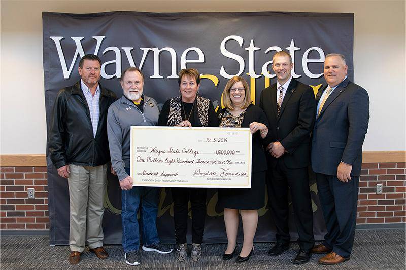 The Gardner Foundation presents Wayne State College with a $1.8 million check. From left to right: Tim Bebee, Kirk Gardner, Leslie Bebee, WSC President Marysz Rames, WSC Athletic Director Mike Powicki, and Wayne State Foundation CEO Kevin Armstrong.