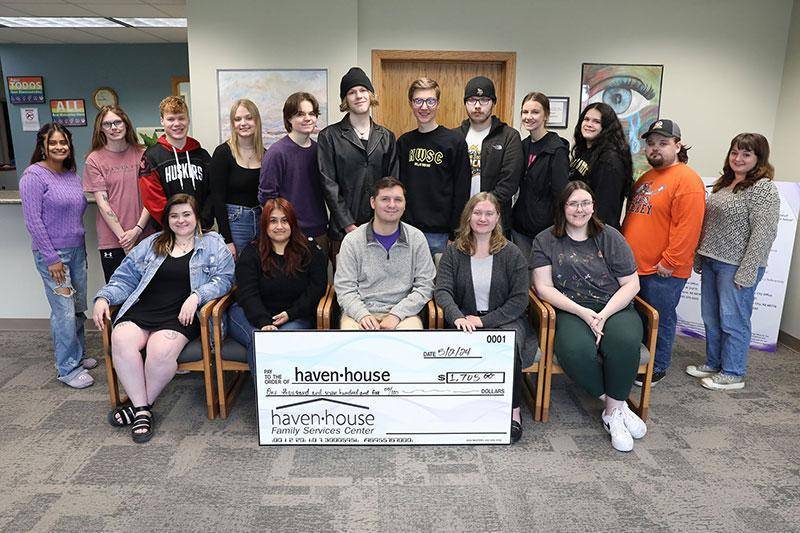 WSC broadcasting students and Haven House representatives pose with a check for funds raised for survivors of domestic abuse