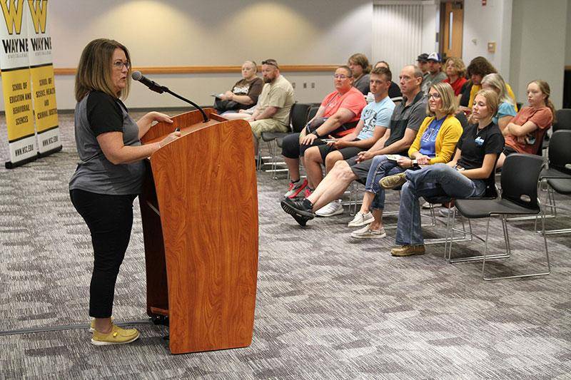 Photo of an admissions representative speaking to a group of students