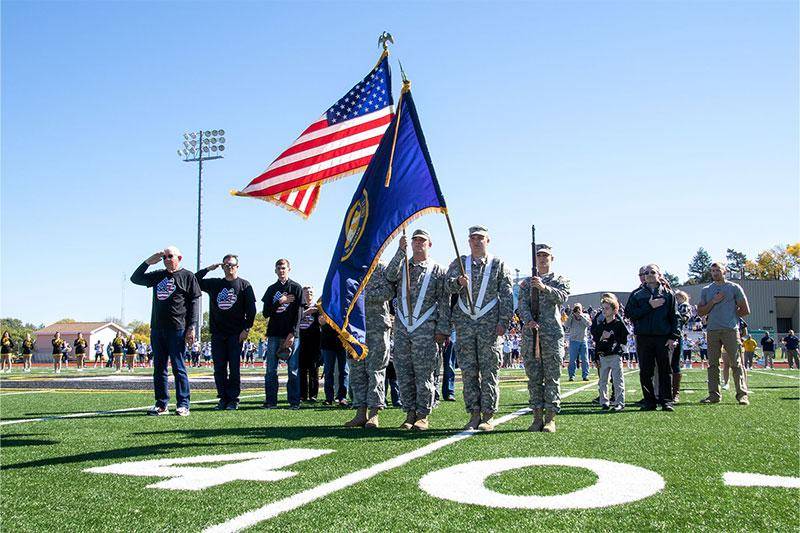 Members of the U.S. military present colors on the Wayne State football field