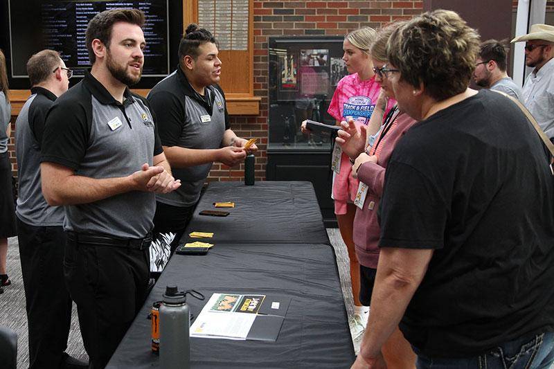 Photo of admissions representatives helping students registering for classes