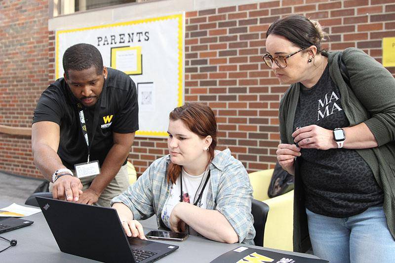 Photo of a student using a laptop to register for classes