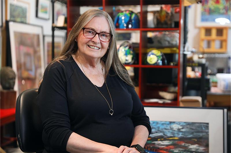 Pearl Hansen poses by her art
