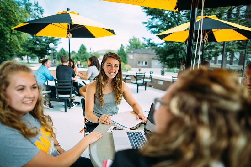 Students study on the library patio