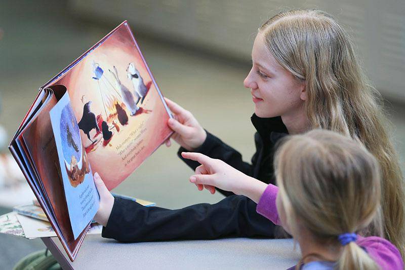 A WSC student reads with a child during a literacy project