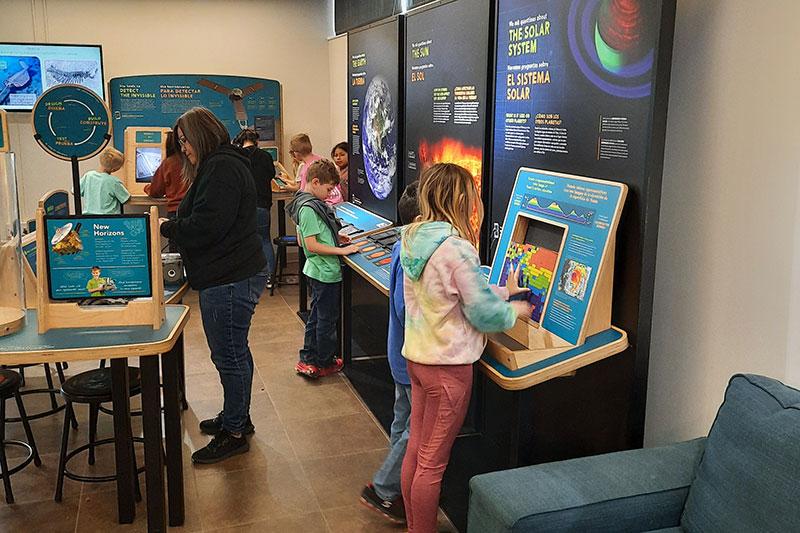 Children interact with the Sun, Earth, Universe exhibit