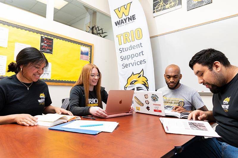 Four TRIO students study at a table