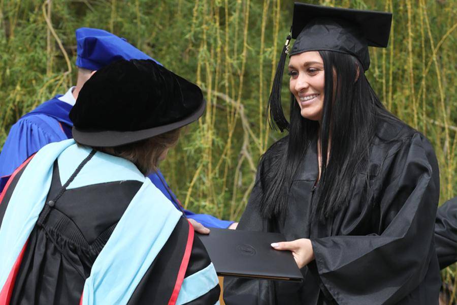 Courtney Neill receives her diploma at the WSC 2026 Spring Commencement Ceremony.