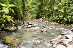 Students take a dip at the base of La Paz waterfall in Costa Rica